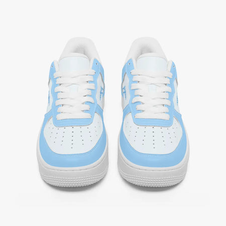 Front-facing top angle of low-top sneakers in sky blue and white leather, displaying clean white laces, sky blue eyestays, and perforated white toe boxes.