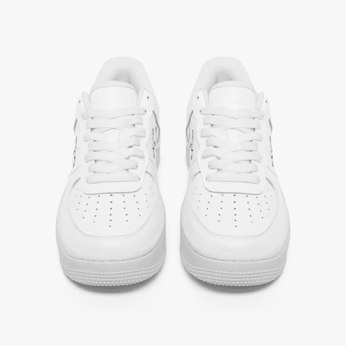 Front-facing top angle of monochromatic white leather low-top sneakers, displaying clean white laces, white eyestays, and perforated toe boxes.