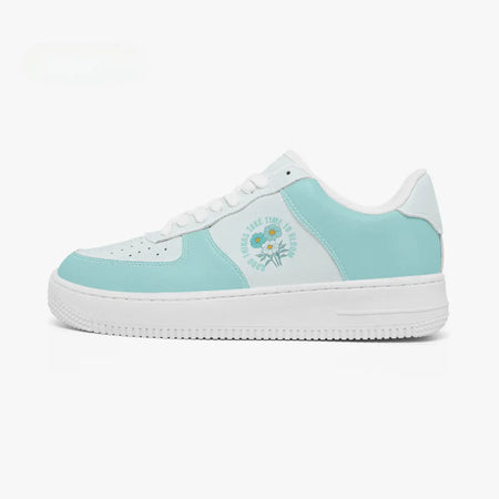Outer side view of the left shoe featuring mint green overlays, white panels, and a "Good Things Take Time To Bloom" flower design facing left.