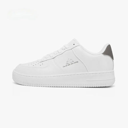A white low-top sneaker with a gray heel accent and a small graphic print on the side, shown in profile against a plain white background.