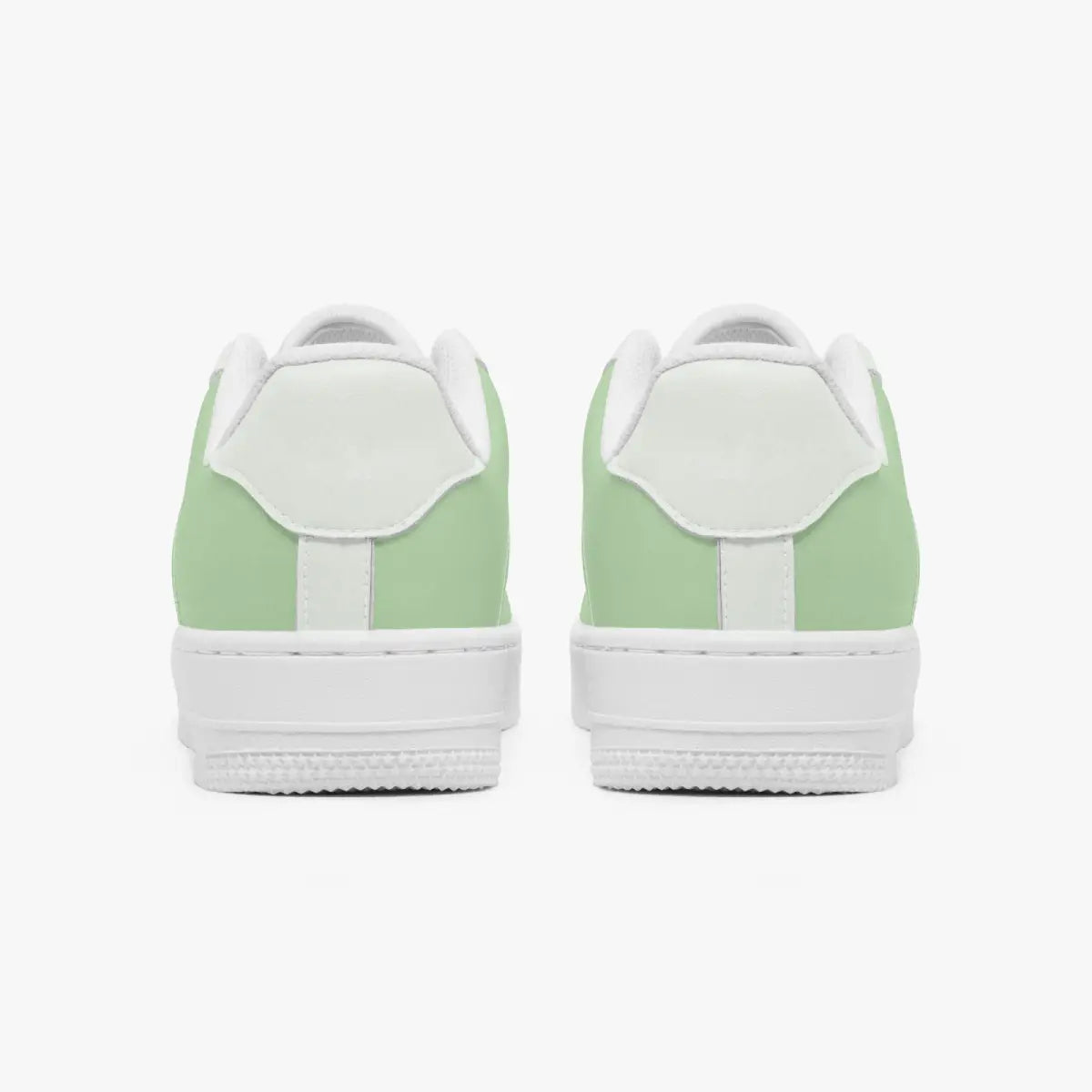 Rear view of a pair of sage green and white sneakers showing the padded heel counters and flat white rubber soles.