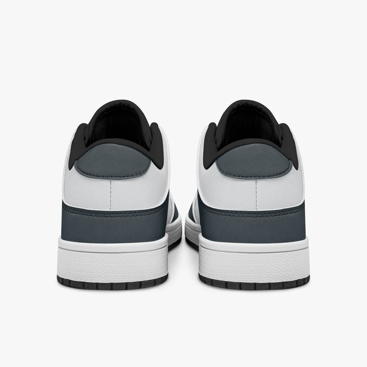 Rear view of slate blue-grey and white sneakers showing slate blue-grey heel overlays, white leather collars, and black interior collar lining above white midsoles.