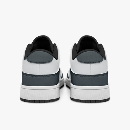 Rear view of slate blue-grey and white sneakers showing slate blue-grey heel overlays, white leather collars, and black interior collar lining above white midsoles.