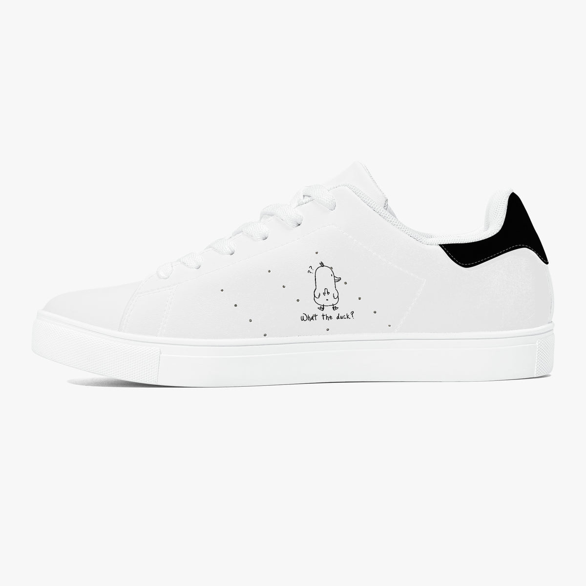 A white low-top sneaker with a black heel tab, white laces, and a small black cartoon graphic on the side with the text 'What's next?'.