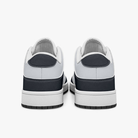 Rear view of navy and white sneakers displaying dark navy heel overlays, white leather collar panels, and two-tone white and black rubber outsoles.