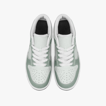 Overhead view of sage green and off-white sneakers showing clean white laces, white padded collar lining, and perforated off-white leather toe boxes.