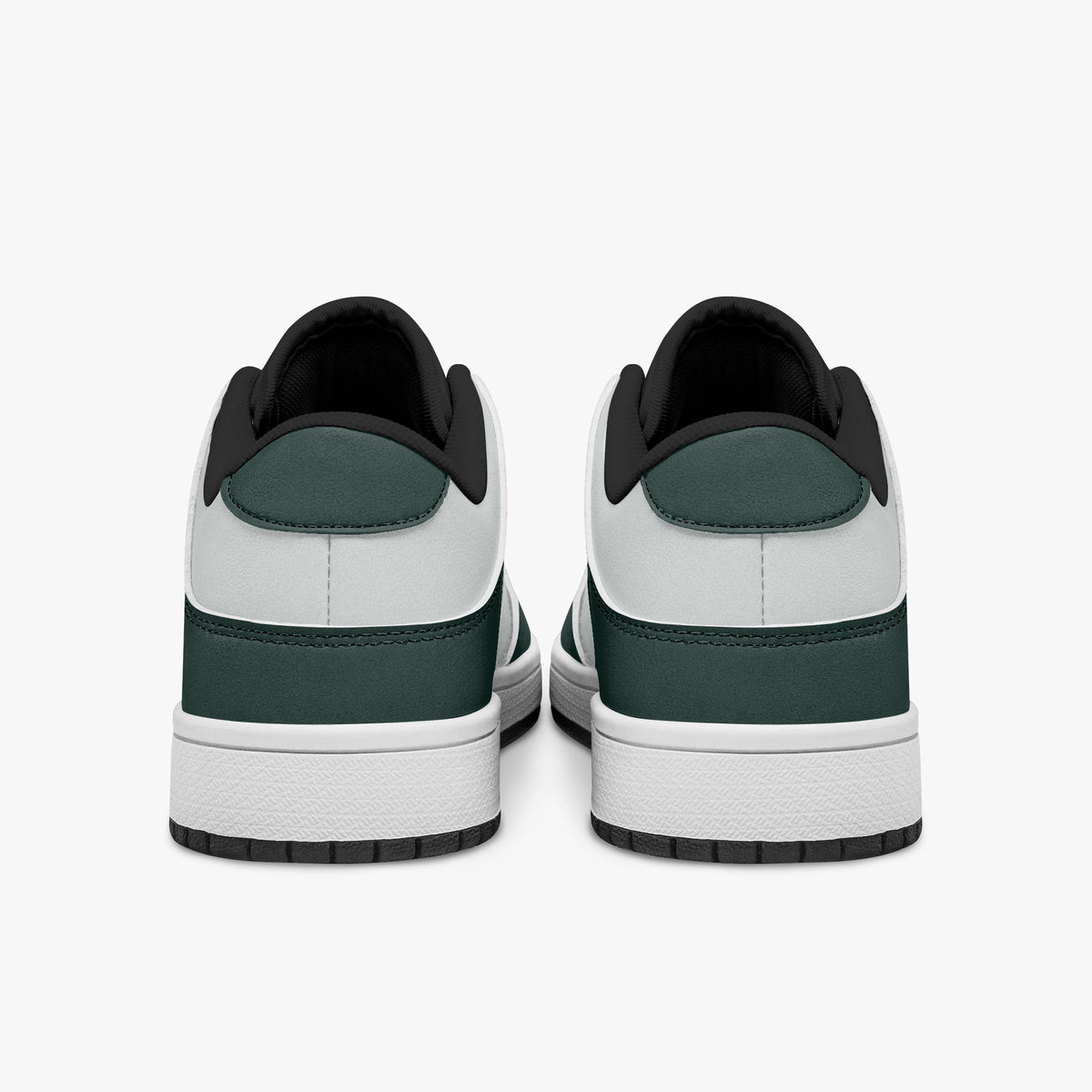Rear view of dark green and white sneakers showing dark green heel overlays, white leather collars, and black interior collar lining above white midsoles.