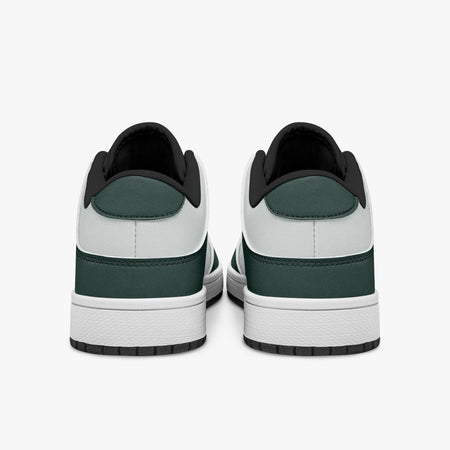 Rear view of dark green and white sneakers showing dark green heel overlays, white leather collars, and black interior collar lining above white midsoles.
