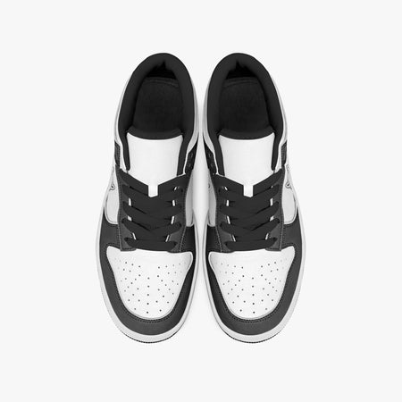 Overhead view of black and white sneakers displaying black laces, black padded collar lining, and perforated white leather toe boxes.