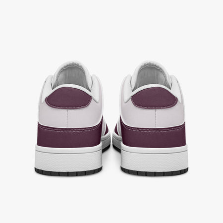 Rear view of burgundy and pale pink sneakers displaying deep burgundy heel overlays, pale pink collar panels, and two-tone white and black rubber outsoles.