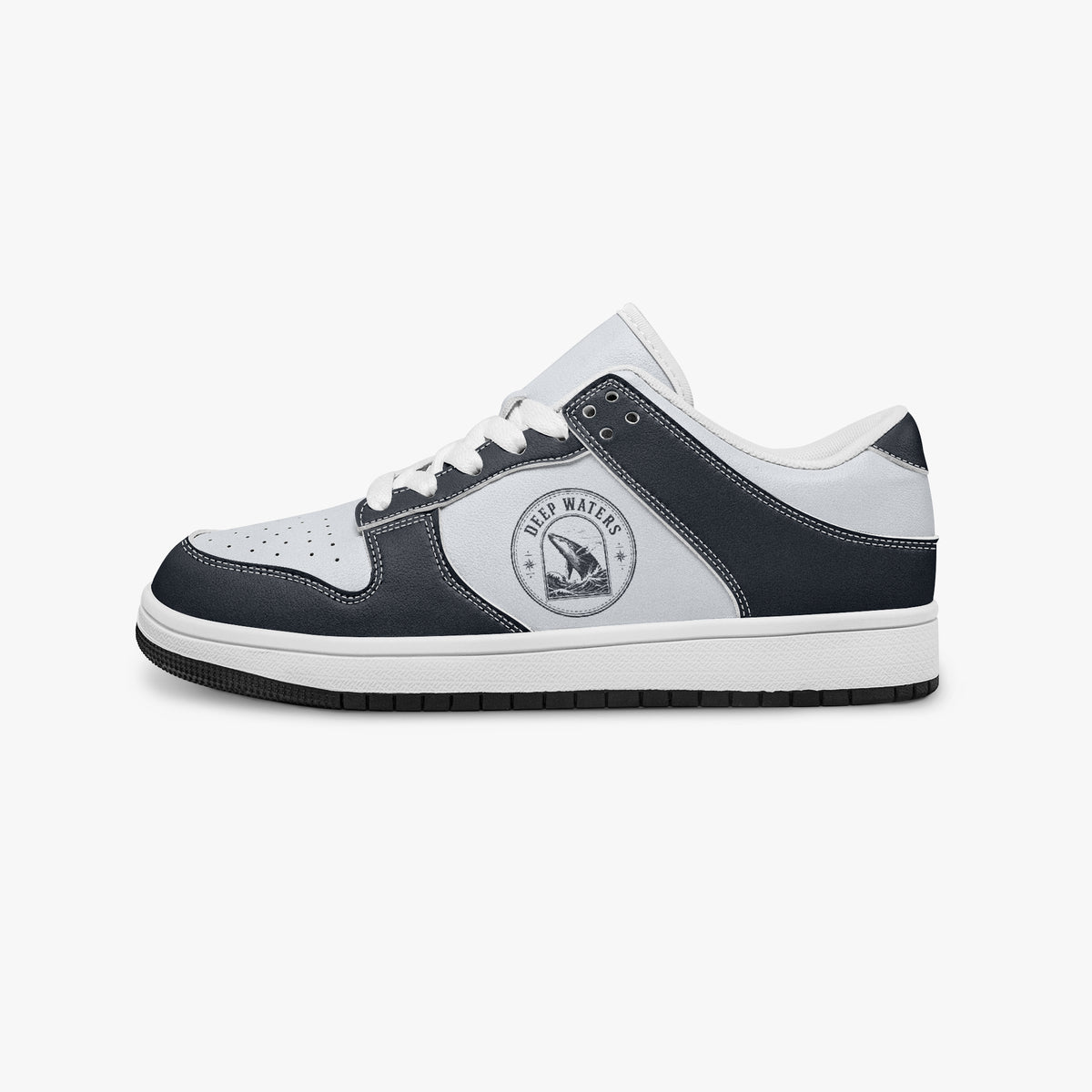 Side profile view of the left sneaker highlighting the dark navy leather overlays, ocean whale illustration, white laces, white interior lining, and contrasting black outsole facing right.