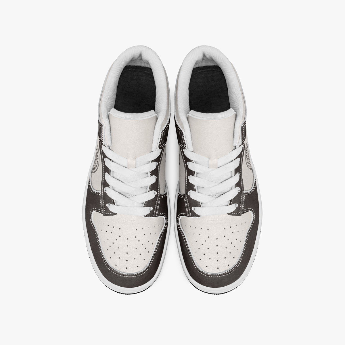 Overhead view of dark brown and cream sneakers showing clean white laces, white padded collar lining, and perforated cream leather toe boxes.