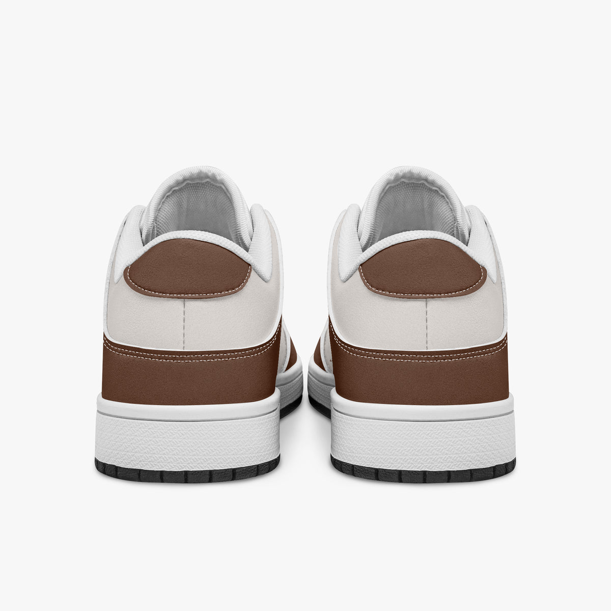 Rear view of brown and cream sneakers displaying coffee brown heel overlays, off-white leather collar panels, and two-tone white and black rubber outsoles.