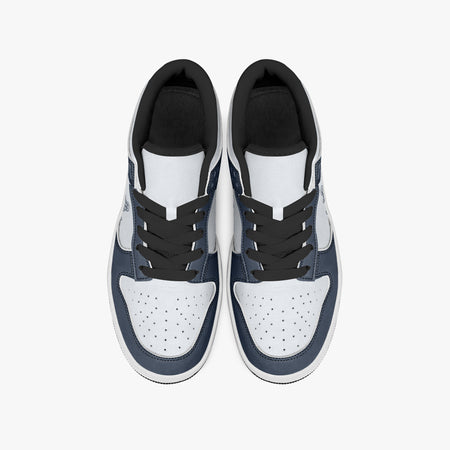 Overhead view of navy blue and white sneakers showing black laces, black padded inner collars, and perforated white leather toe boxes.