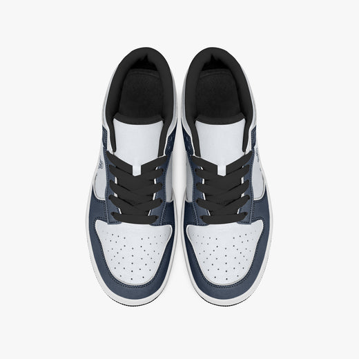 Overhead view of navy blue and white sneakers showing black laces, black padded inner collars, and perforated white leather toe boxes.