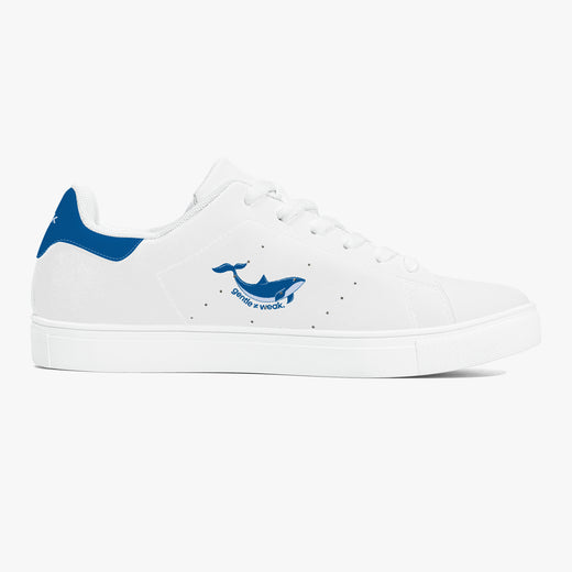 A white low-top sneaker with blue accents, featuring a blue whale graphic and the text 'DIVING WORLD' on the side, set against a clean white background.