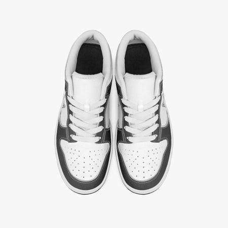 Overhead view of black and white sneakers showing clean white laces, white padded collar lining, and perforated white leather toe boxes.