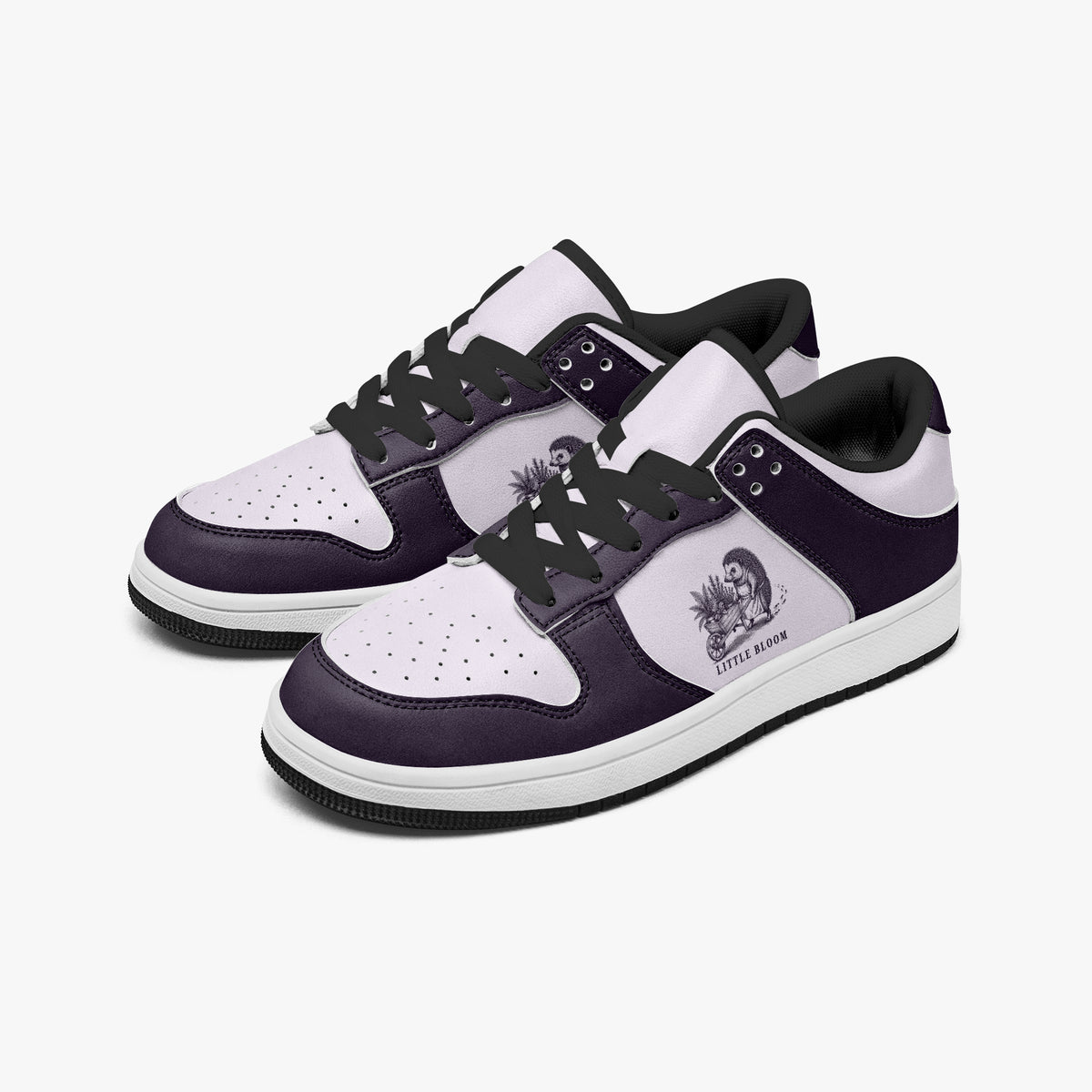 Angled three-quarter view of low-top sneakers in deep plum purple and pale lilac leather, featuring a hedgehog with a flower wheelbarrow graphic with "LITTLE BLOOM", black laces, and a black inner lining.