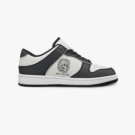 Side profile view of the right sneaker showcasing the black and white color blocking, "UNTIL THE END" graphic, black laces, and black rubber outsole facing right.