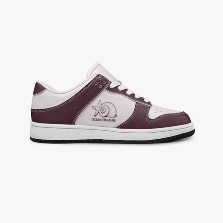 Side profile view of the right sneaker showcasing the burgundy leather overlays, seashell emblem, white eyelet lacing, and contrasting black outsole facing right.