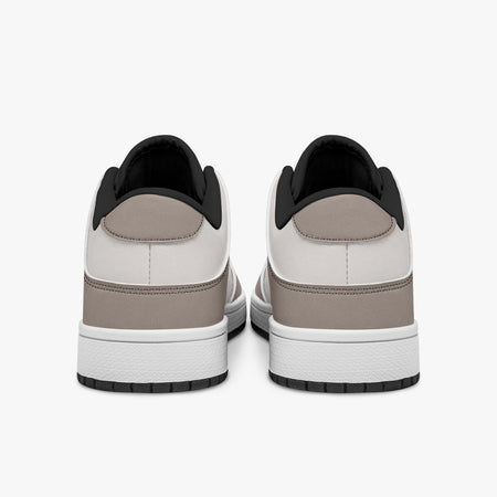 Rear view of taupe and off-white sneakers showing taupe leather heel overlays, light off-white collar panels, and black interior collar lining above white midsoles.
