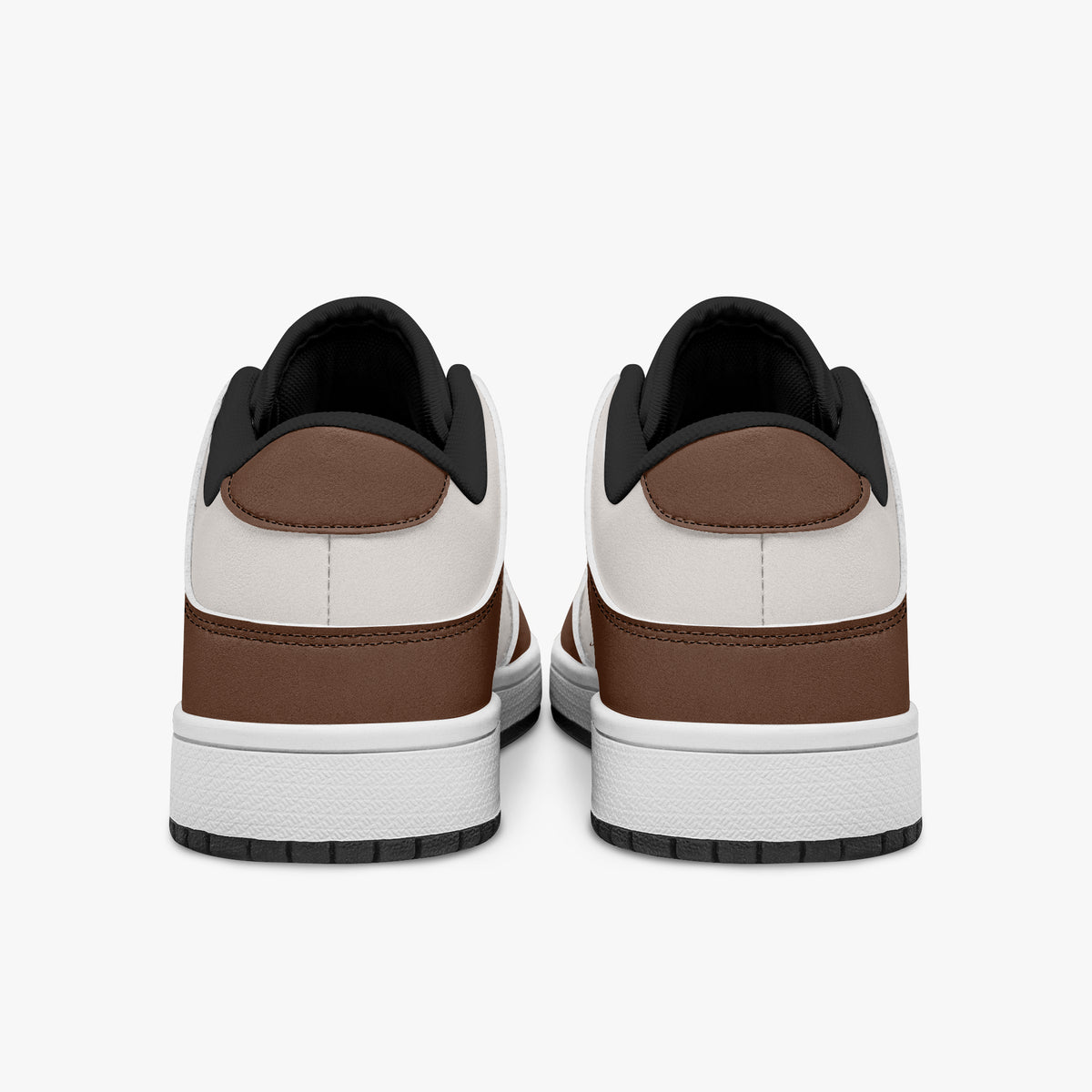 Rear view of brown and cream sneakers showing dark brown heel overlays, off-white leather collars, and black interior collar lining above white midsoles.