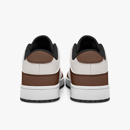 Rear view of brown and cream sneakers showing dark brown heel overlays, off-white leather collars, and black interior collar lining above white midsoles.