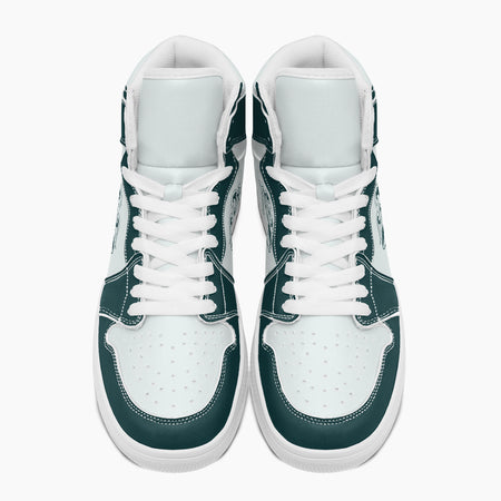 Overhead top-down view of high-top sneakers highlighting dark teal eyestays, white lacing, and perforated white leather vamps.