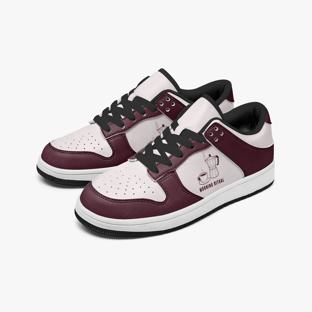 Angled three-quarter view of low-top sneakers in burgundy and pale pink leather, featuring a moka pot and coffee cup illustration with "MORNING RITUAL", black laces, and a black inner lining.