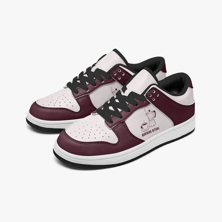 Angled three-quarter view of low-top sneakers in burgundy and pale pink leather, featuring a moka pot and coffee cup illustration with "MORNING RITUAL", black laces, and a black inner lining.