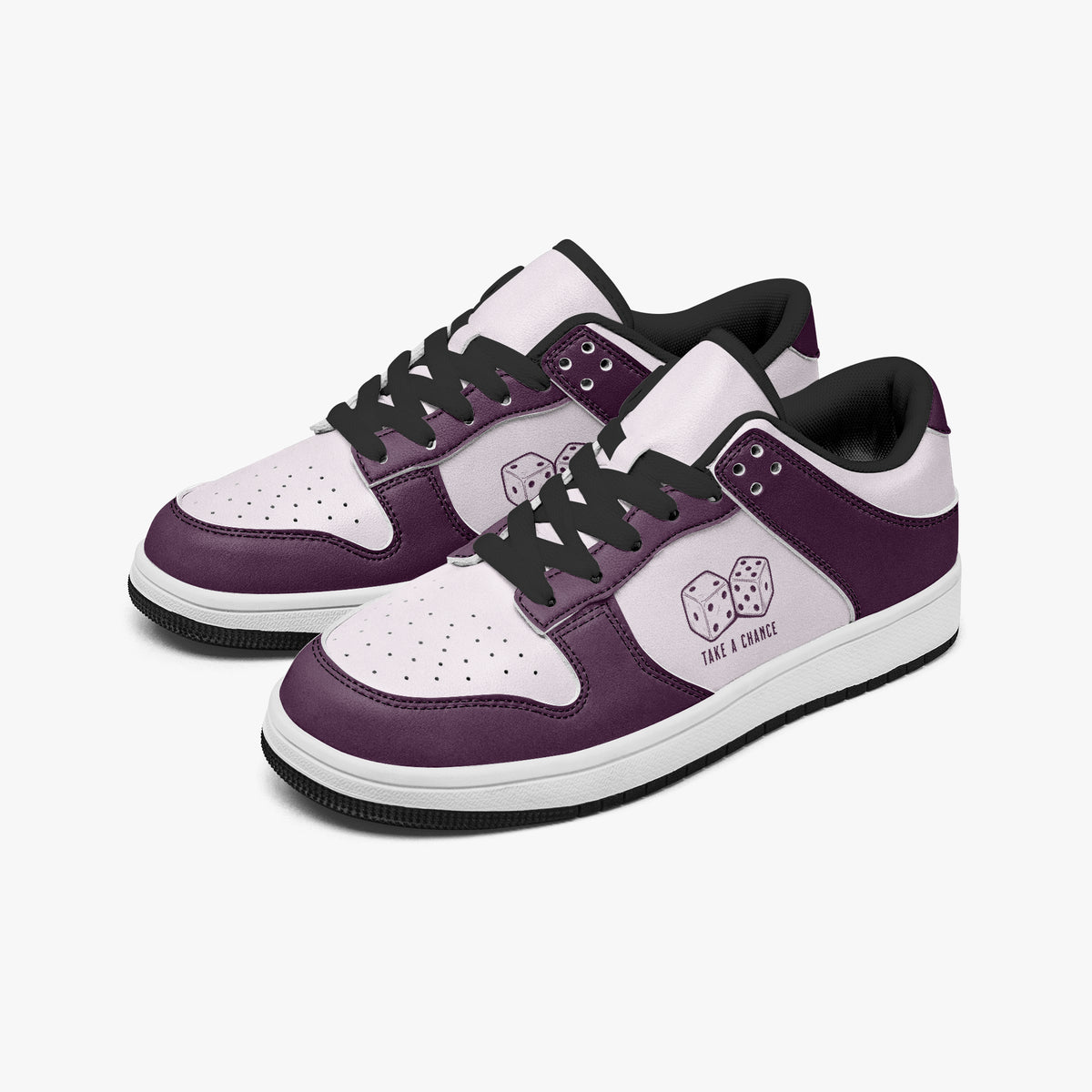 Angled three-quarter view of low-top sneakers in plum purple and pale lilac leather, featuring a pair of dice with "TAKE A CHANCE" on the side panel and black laces.
