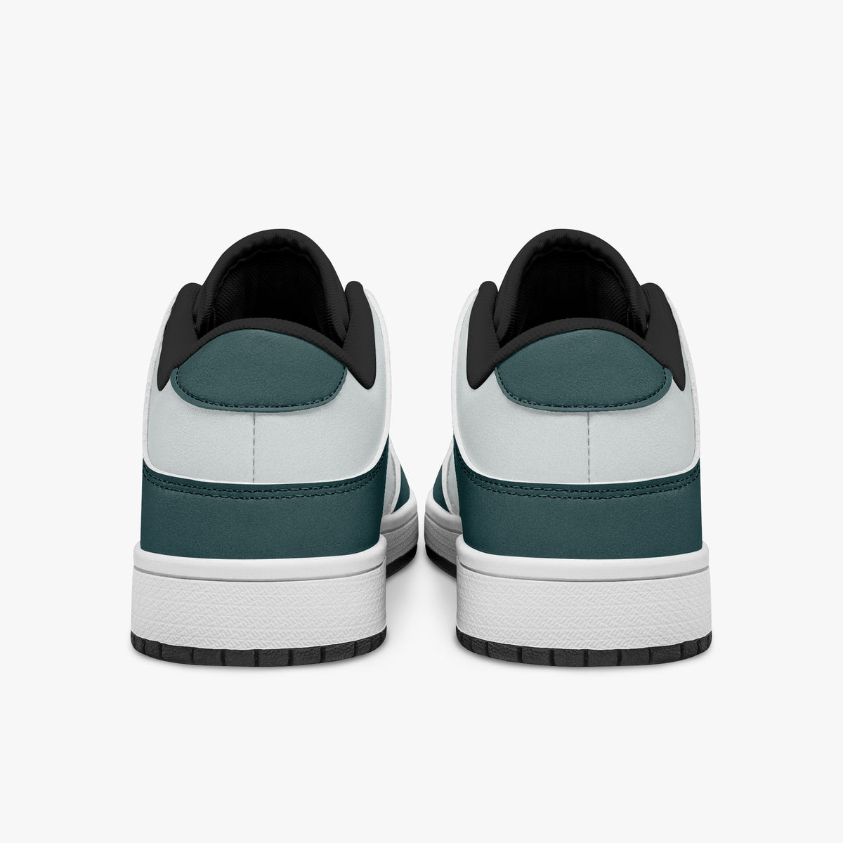 Rear view of the sneakers displaying deep teal heel overlays, white leather panels, and two-tone white and black rubber outsoles.