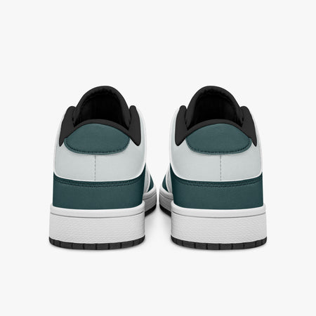 Rear view of the sneakers displaying deep teal heel overlays, white leather panels, and two-tone white and black rubber outsoles.