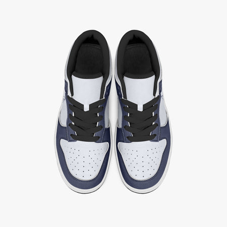 Overhead view of navy blue and white sneakers displaying black laces, black padded collar lining, and perforated white leather toe boxes.