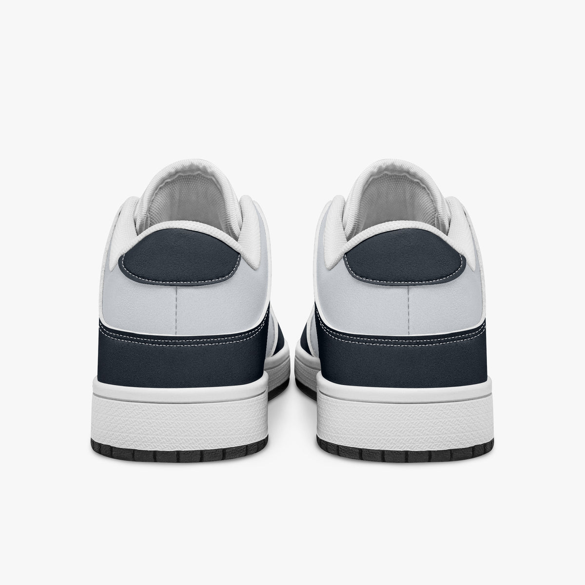 Rear view of navy blue and off-white sneakers displaying deep navy heel overlays, white leather collar panels, and two-tone white and black rubber outsoles.