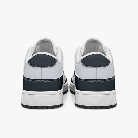 Rear view of navy blue and off-white sneakers displaying deep navy heel overlays, white leather collar panels, and two-tone white and black rubber outsoles.