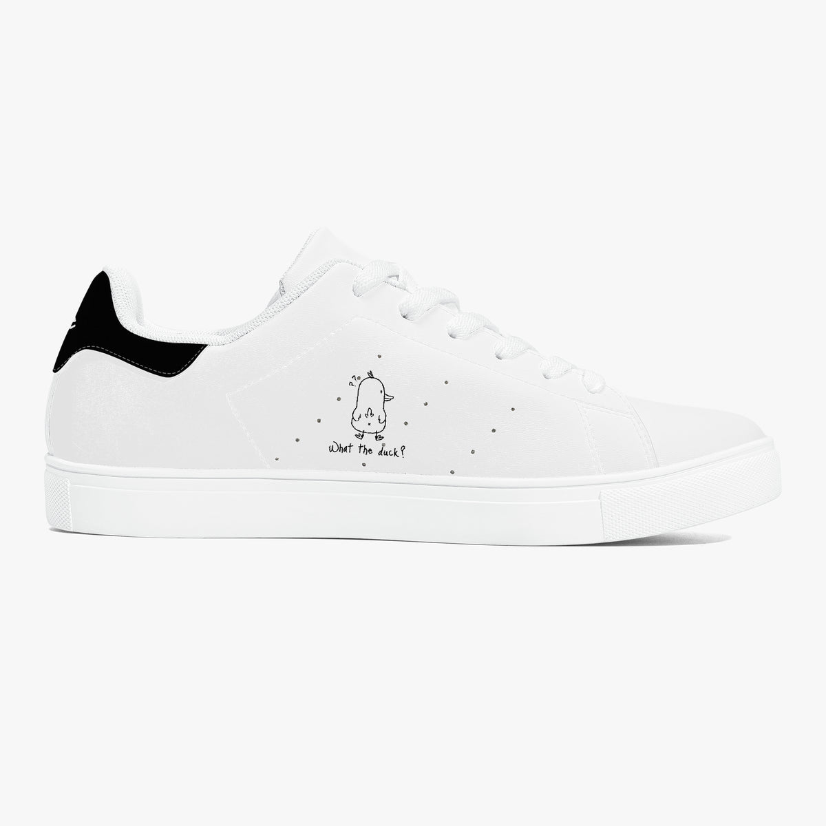A white low-top sneaker with a black heel tab, white laces, and a small black cartoon graphic with the text 'what do we?' on the side, shown against a plain white background.