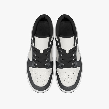 Overhead view of black and white sneakers displaying black laces, black padded collar lining, and perforated white leather toe boxes.