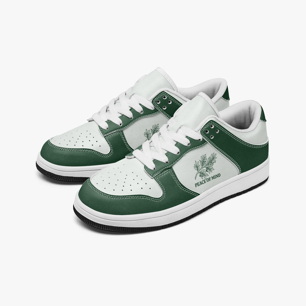 Angled three-quarter view of low-top sneakers in forest green and white leather, featuring a botanical branch illustration with "PEACE OF MIND", white laces, and a white inner lining.