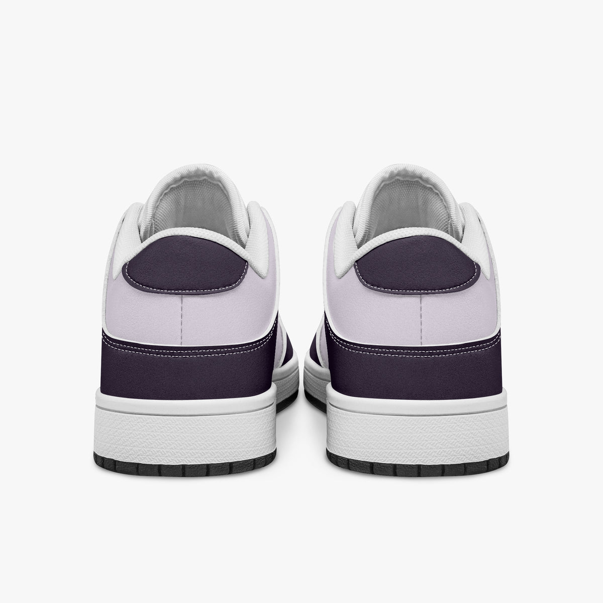 Rear view of plum purple and lilac sneakers displaying deep purple heel overlays, pale lilac leather collar panels, and two-tone white and black rubber outsoles.