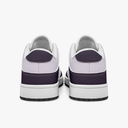 Rear view of plum purple and lilac sneakers displaying deep purple heel overlays, pale lilac leather collar panels, and two-tone white and black rubber outsoles.