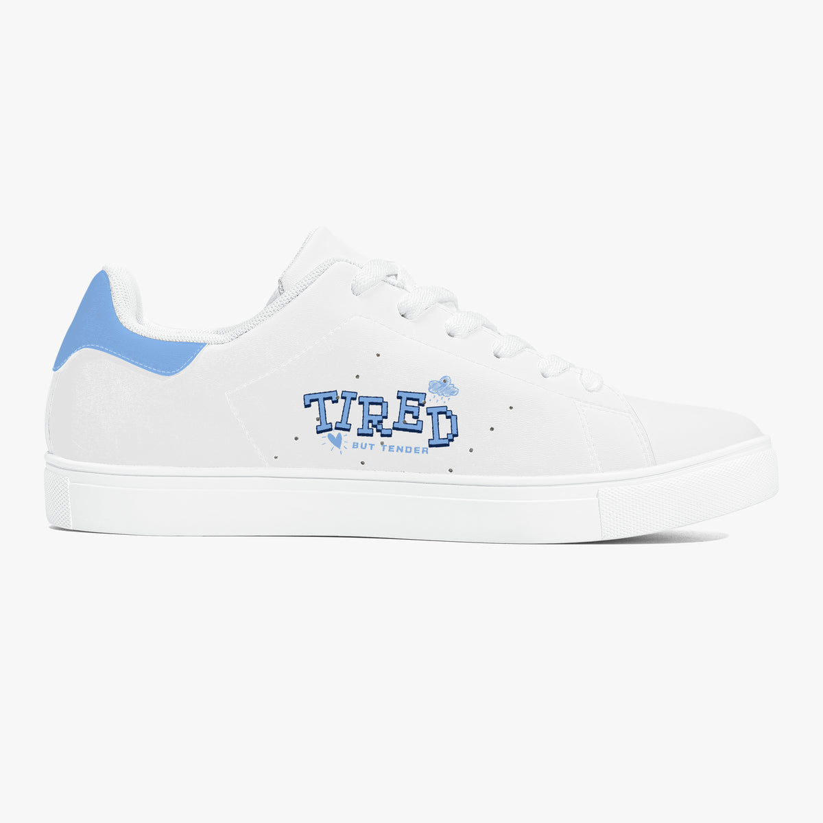 A white low-top sneaker with a light blue heel tab, white laces, and a blue 'TIRED' graphic on the side, shown against a plain white background.