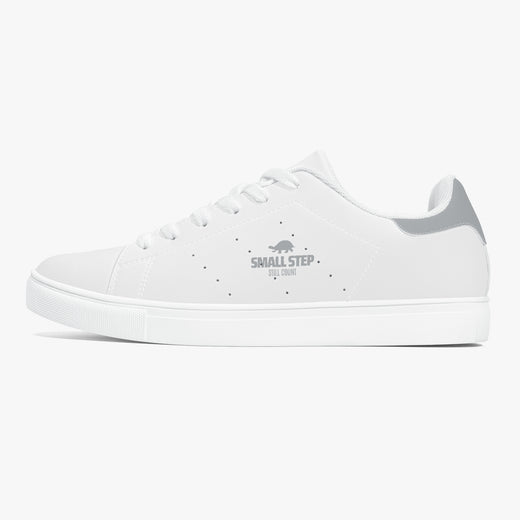 A white low-top sneaker with a gray heel accent and a gray 'SMALL STEP by CUBAN' logo printed on the side, shown against a light gray background.